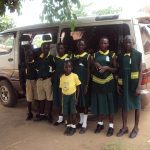 Pupils waiting to board mini bus to school